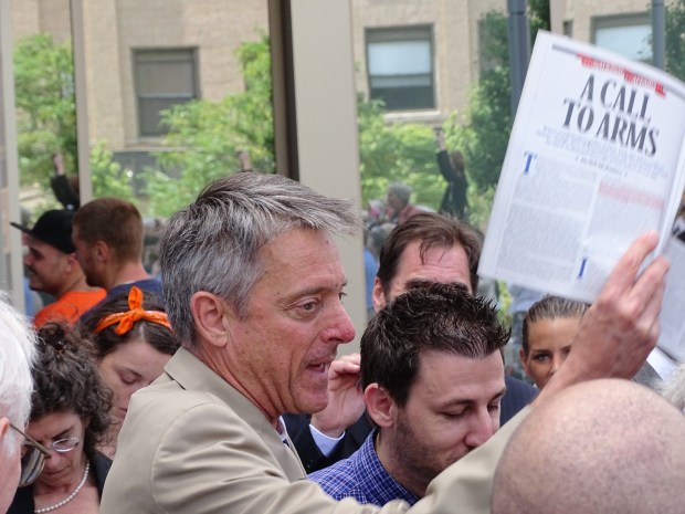 DA Sam Sutter holding Rolling Stone Magazine 